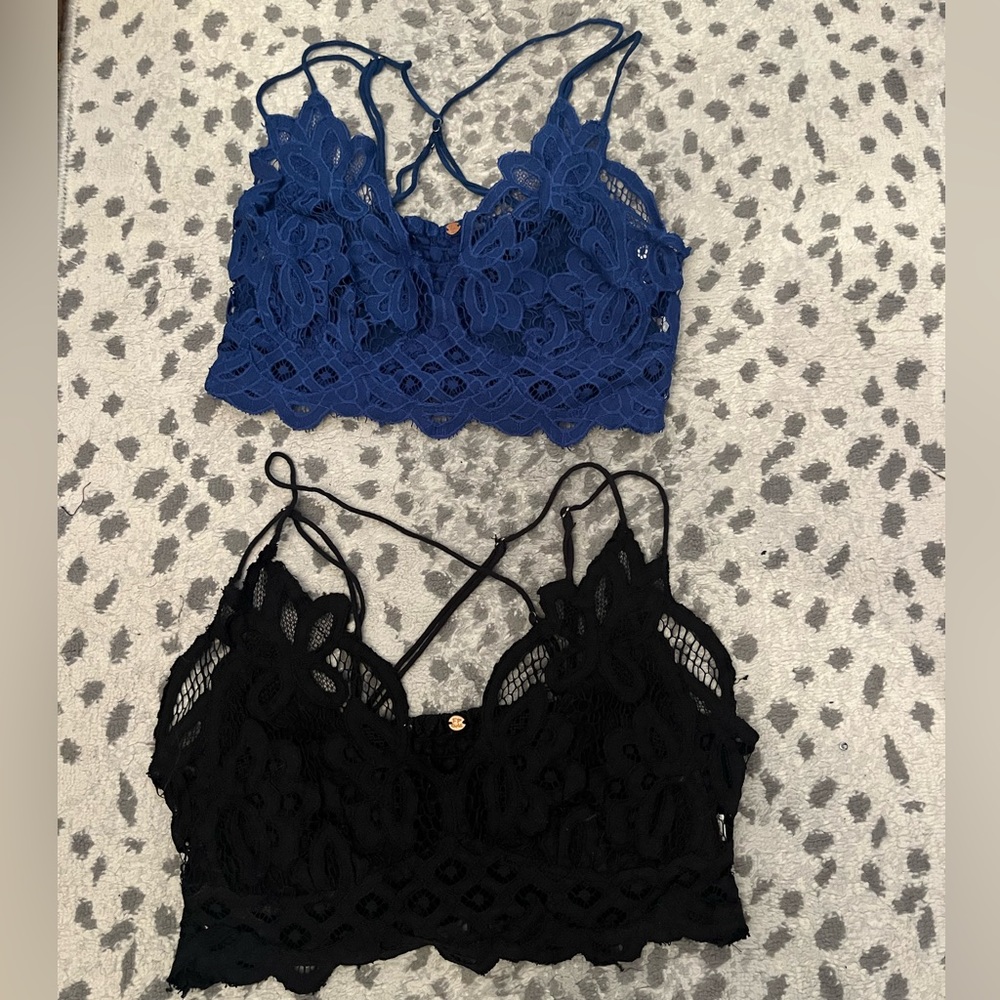 Two women's lace Free People crop tops. Blue and black. Size medium
